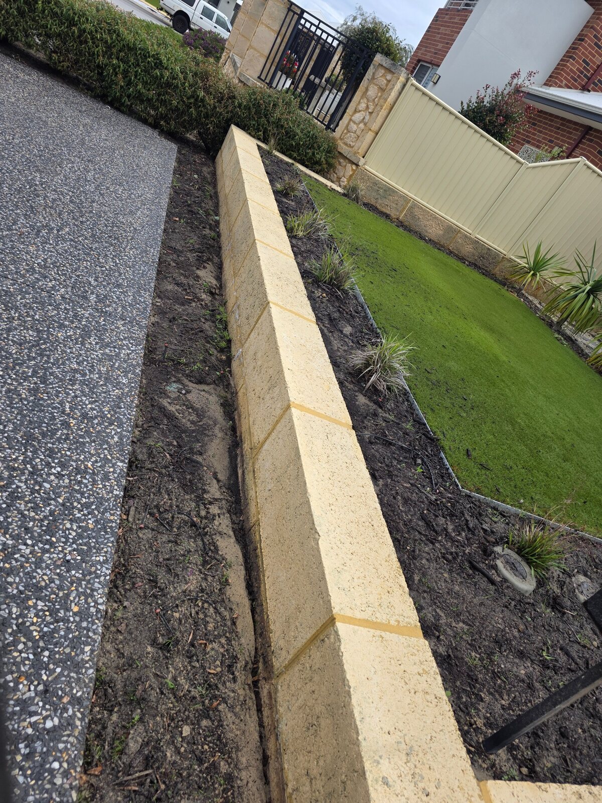 Exposed aggregate driveway and retaining wall after cleaning
