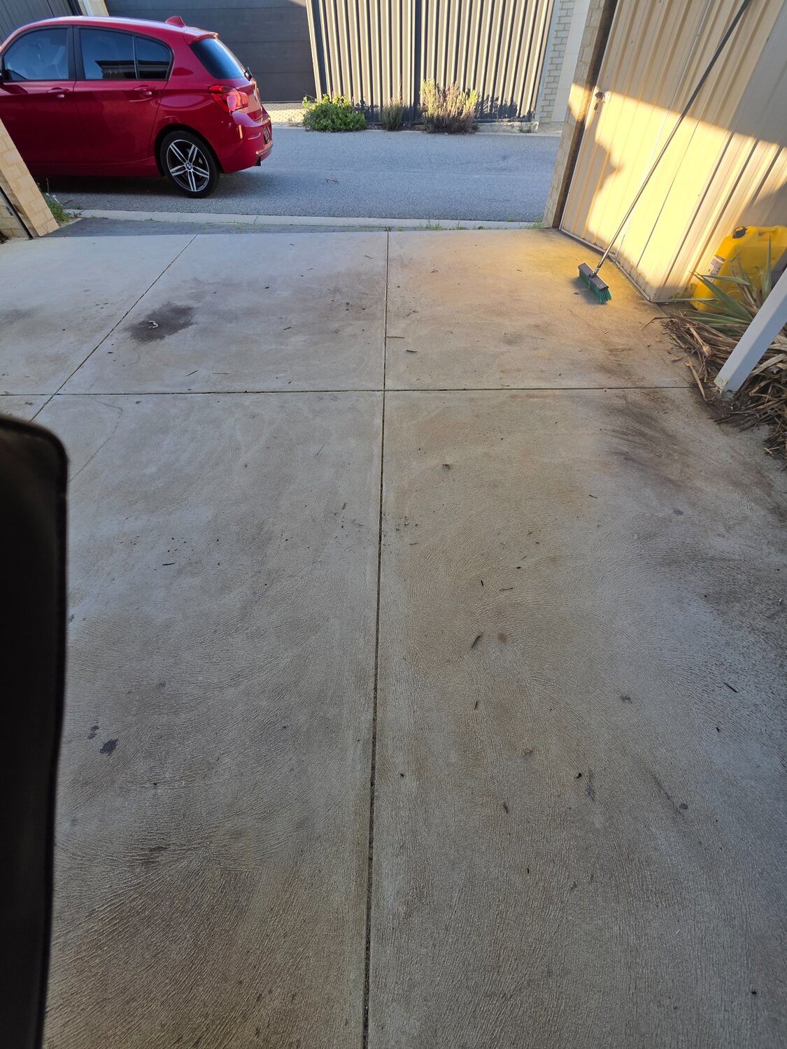 Garage concrete floor with oil staining before cleaning